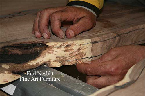 close up of Earl marking notch for glass on mesquite slabs for custom made live edge dining table